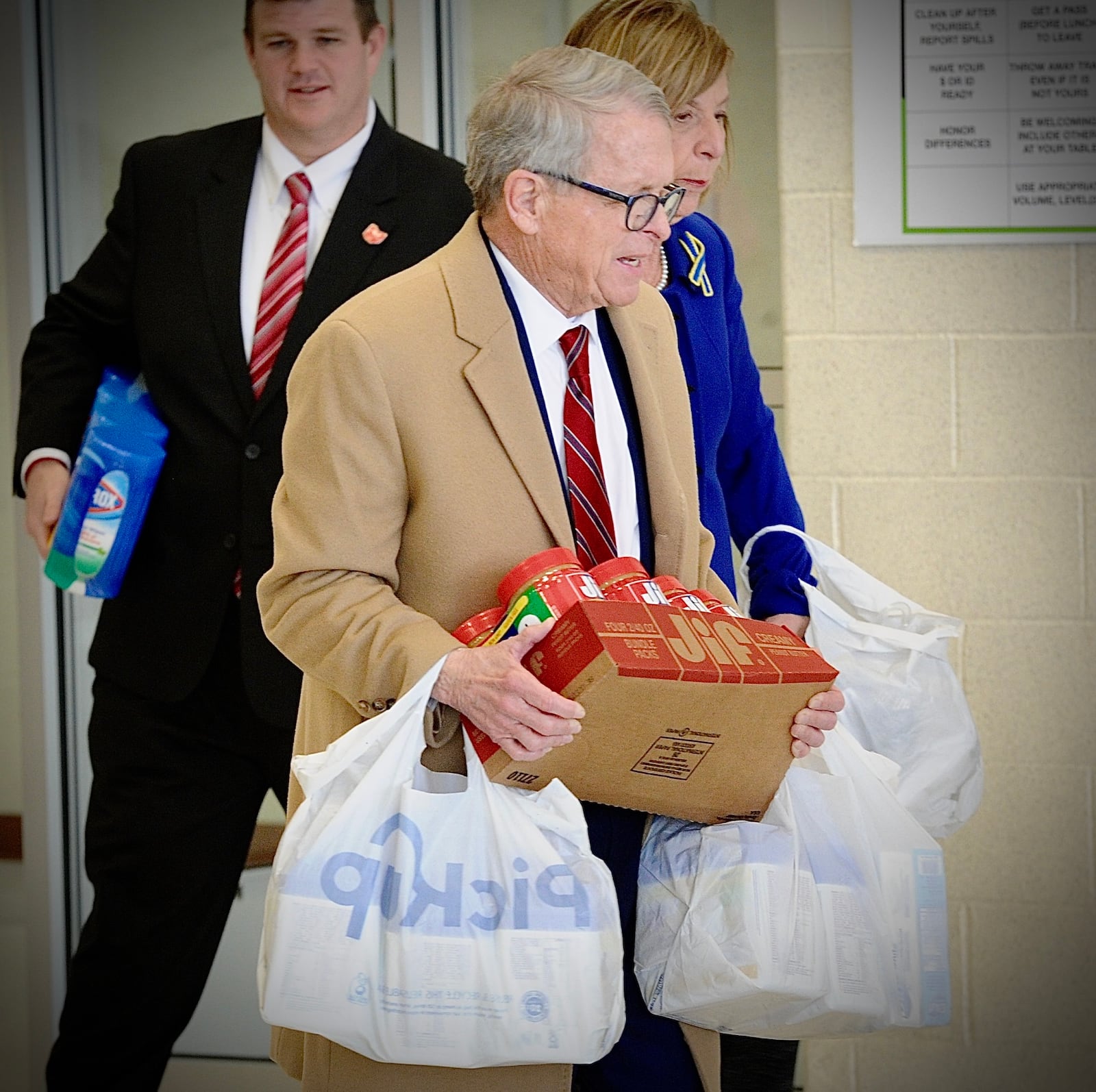 Ohio Governor Mike DeWine with his wife Fran, carry in peanut butter, cleaning supplies, clothes and diapers for children to the Emerge Recovery and Trade Initiative to be transported to help Ukrainian refugees. On Friday April 1, 2022 Gov. DeWine talked with charitable organizations near Xenia regarding help for Ukrainian refugees. MARSHALL GORBY\STAFF