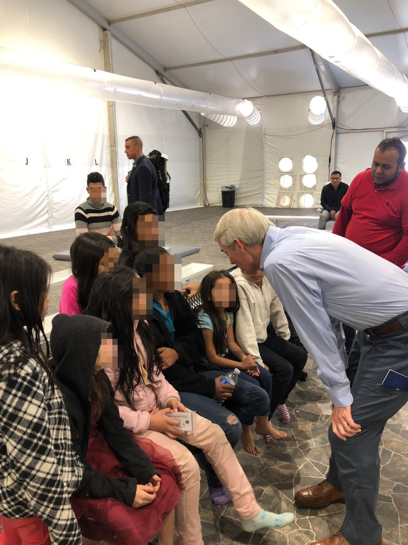 U.S. Senator Rob Portman meets with children at a holding facility near the Mexican border last weekend.