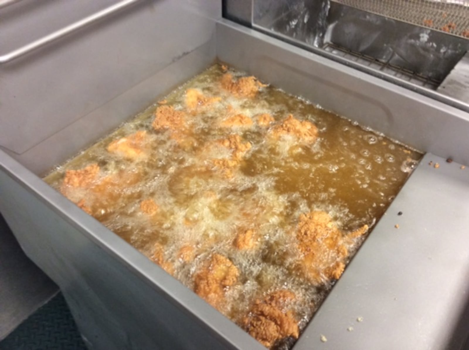 Chicken in the fryer at “Ms. Pam’s Old Dayton Style Golden Fried Chicken” on Wayne Avenue near Belmont High School. MARK FISHER/STAFF