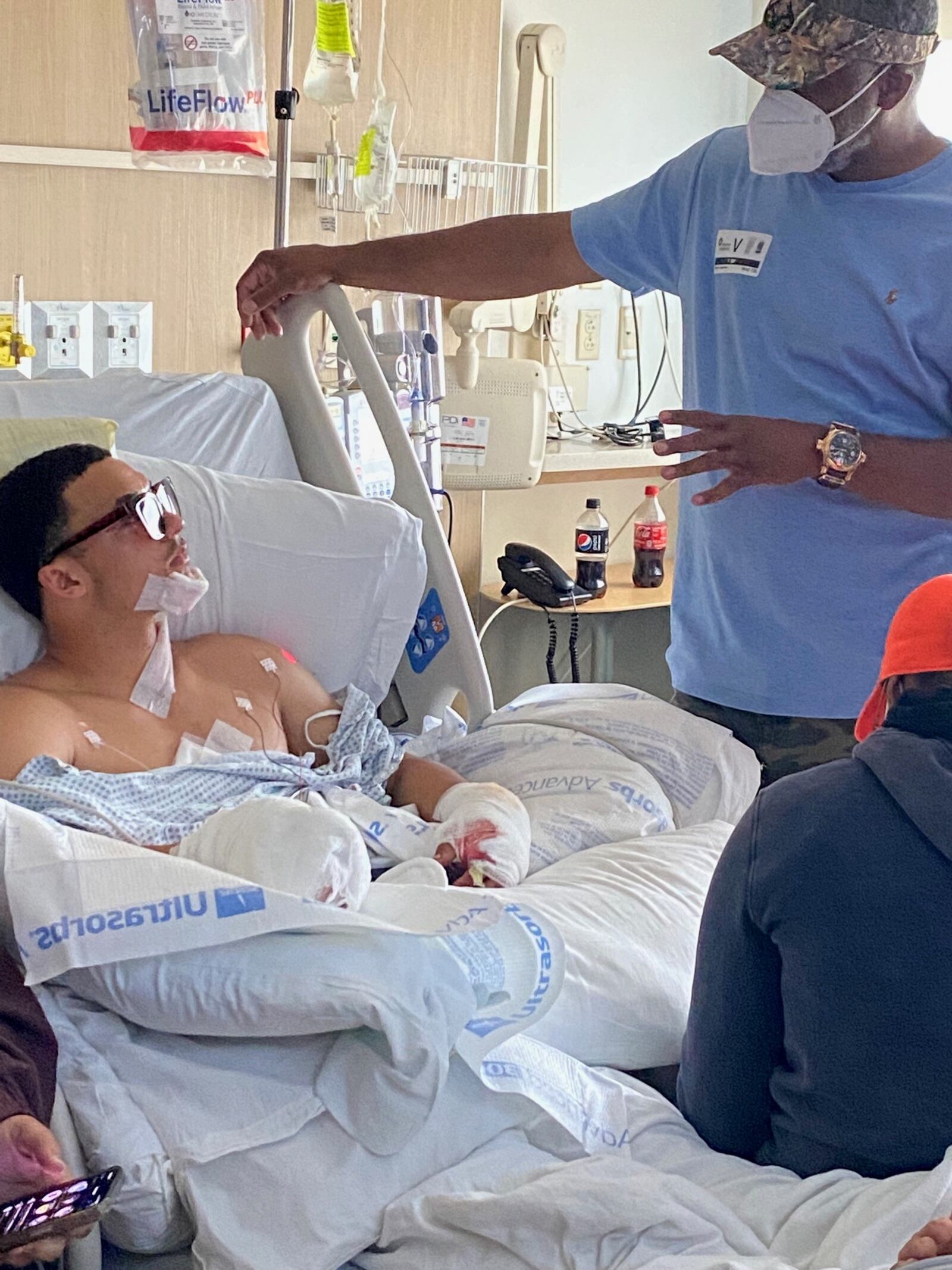 Trotwood Madison head coach Jeff Graham visiting Rams’ standout linebacker Issiah Evans in his room t Dayton Children’s Hospital. Evans suffered serious injuries, including the loss of his right hand, in a fireworks accident on July 5. Issiah also had ACL surgery in the spring, but he vows he will play again this season. (Contributed photo)