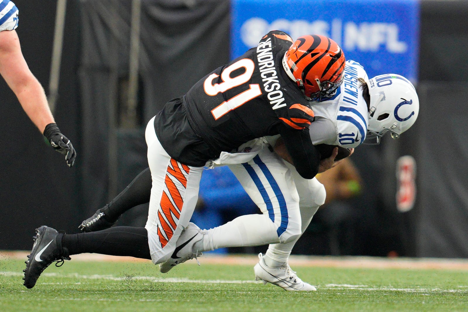 Cincinnati Bengals defensive end Trey Hendrickson (91) sacks Indianapolis Colts quarterback Gardner Minshew II (10) in the second half of an NFL football game in Cincinnati, Sunday, Dec. 10, 2023. (AP Photo/Jeff Dean)