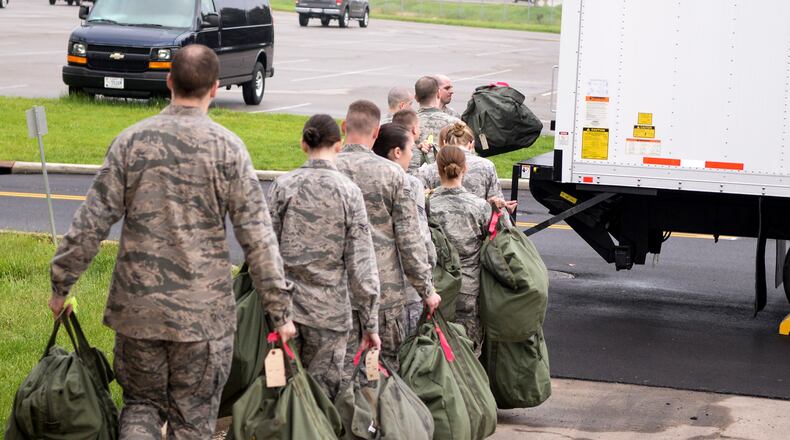 FILE: Airmen load their mobility bags onto a waiting cargo truck after processing through the mobility bag issue line as part of a base exercise at Wright-Patterson Air Force Base in 2015. (U.S. Air Force photo by Wesley Farnsworth/Released)