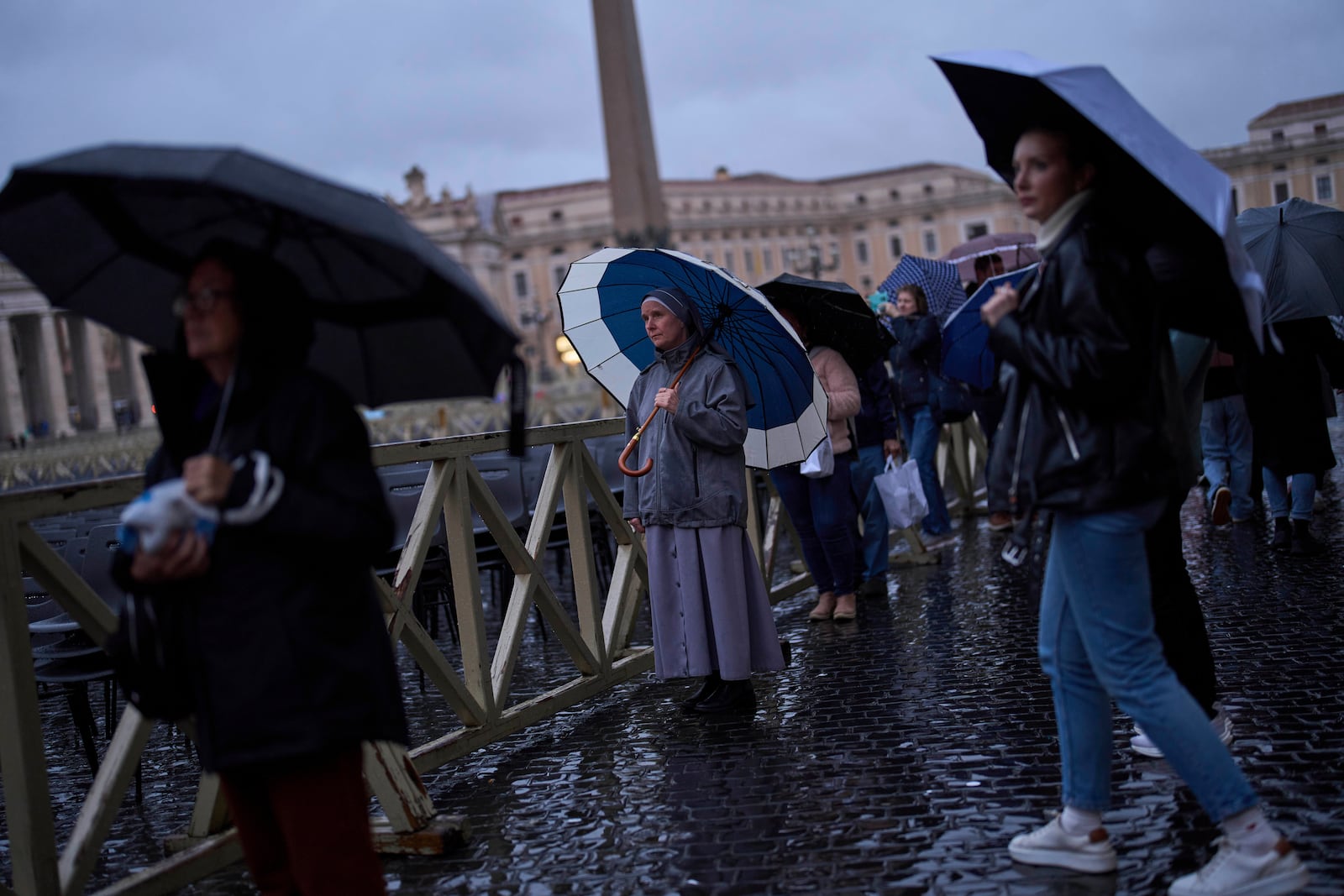 People pray as they follow a live broadcasted Rosary prayer for Pope Francis, in St. Peter's Square at the Vatican, Wednesday, March 12, 2025. (AP Photo/Francisco Seco)