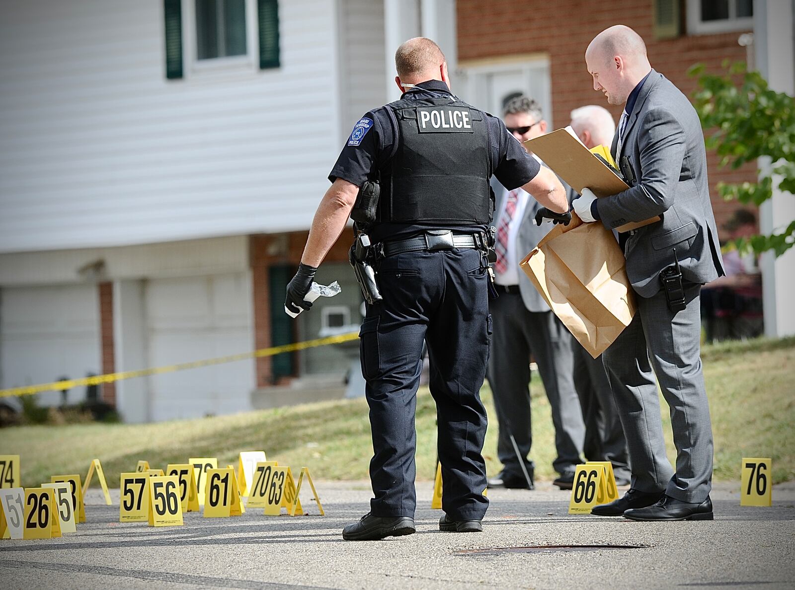 Miami Twp. police investigate and collect evidence on Verdi Drive after multiple shots were fired Tuesday, Sept. 26. MARSHALL GORBY\STAFF