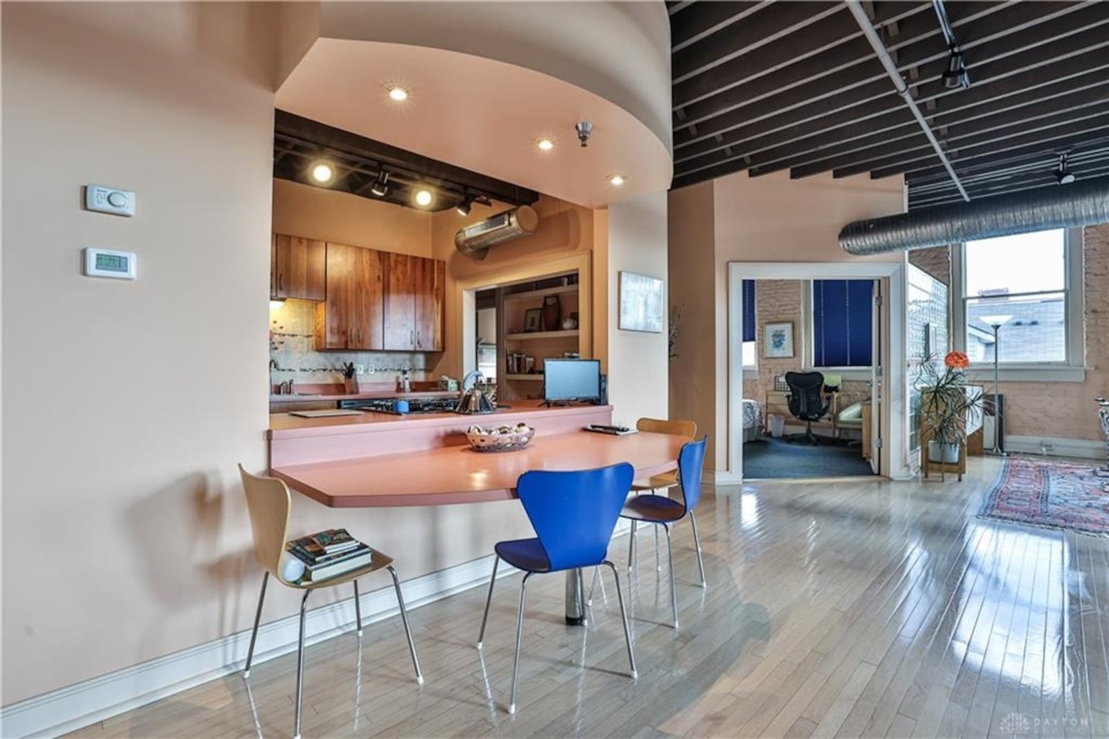 A large cut-out with an extended arched counter looks into the spacious kitchen. CONTRIBUTED