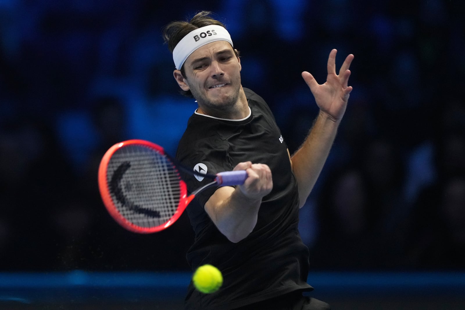 United States' Taylor Fritz returns the ball to Australia's Alex de Minaur during their singles tennis match of the ATP World Tour Finals at the Inalpi Arena, in Turin, Italy, Thursday, Nov. 14, 2024. (AP Photo/Antonio Calanni)