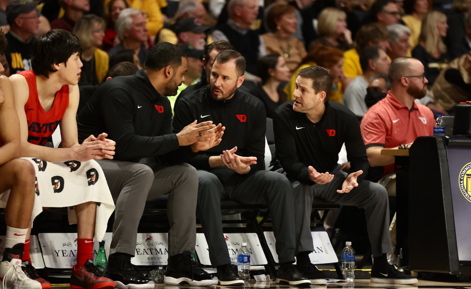 Dayton coaches Ricardo Greer, James Kane and Darren Hertz talk on the bench during a game against Virginia Commonwealth on Tuesday, Feb. 7, 2023, at the Siegel Center in Richmond, Va. David Jablonski/Staff