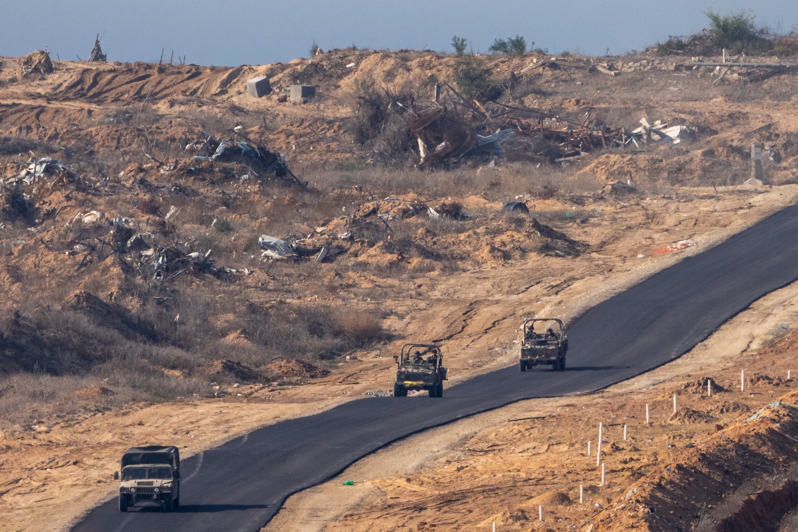 FILE - Israeli military vehicles move inside the Gaza Strip, as seen from southern Israel, on Jan. 7, 2025. (AP Photo/Ariel Schalit, File)