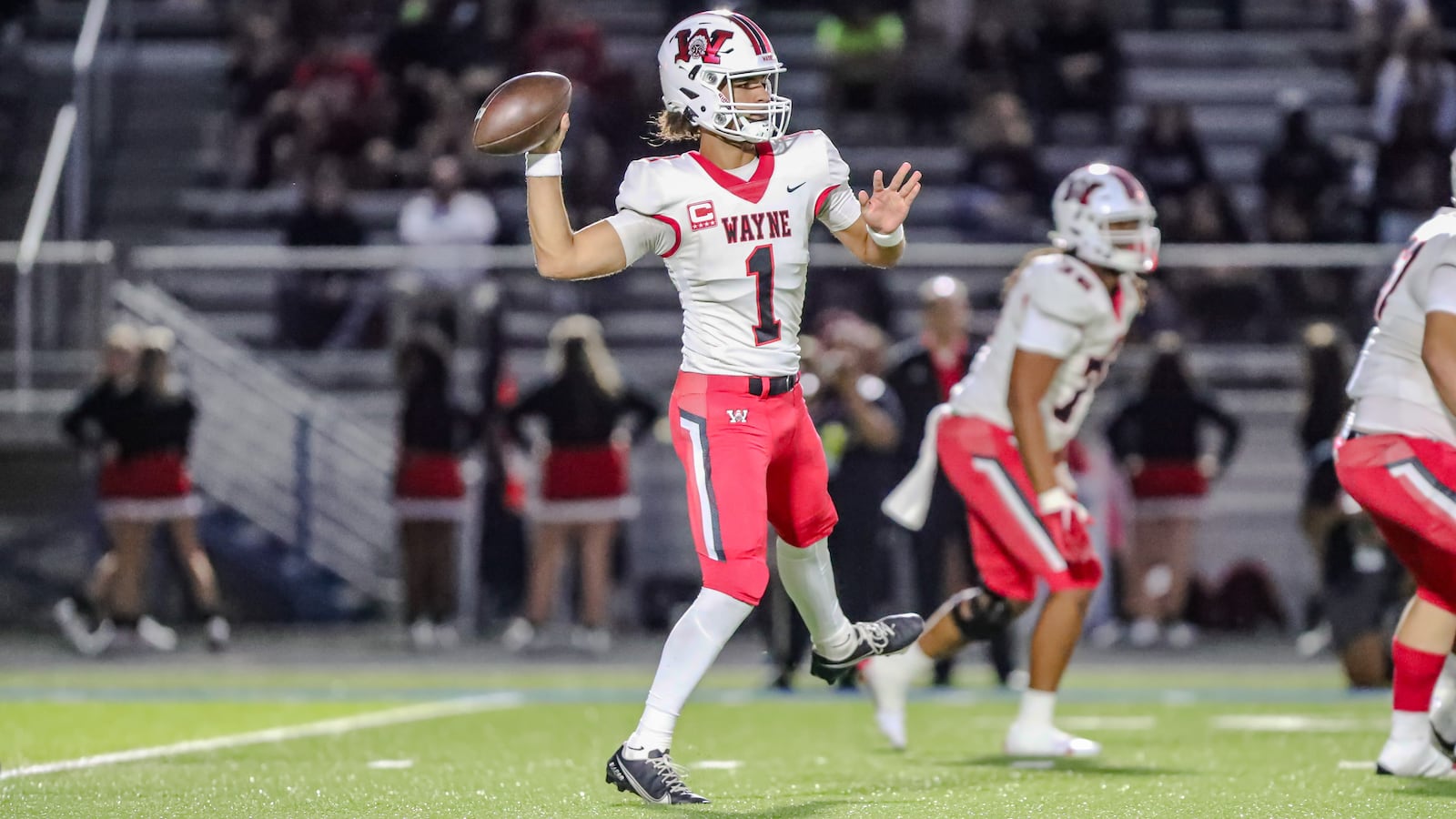 Wayne High School senior quarterback Tyrell Lewis prepares to throw a pass during their game against Springfield on Friday night in Springfield. The Warriors won 36-6. CONTRIBUTED PHOTO BY MICHAEL COOPER