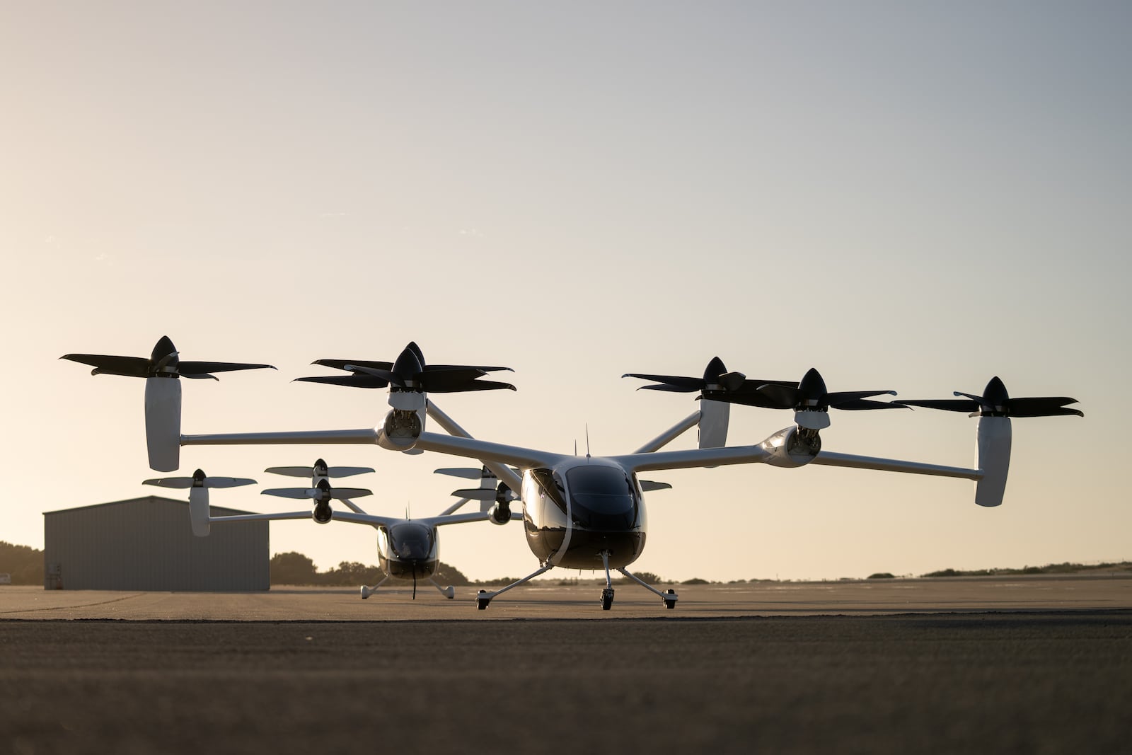 Two of Joby’s prototype electric air taxi aircraft at the company’s flight test and manufacturing facilities in Marina, California. Joby Aviation photo