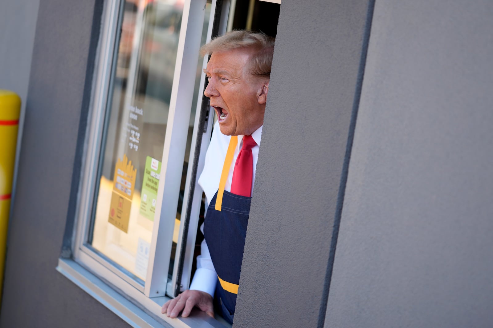 Republican presidential nominee former President Donald Trump speaks while standing at a drive-thru window during a campaign stop at a McDonald's, Sunday, Oct. 20, 2024, in Feasterville-Trevose, Pa. (AP Photo/Evan Vucci)