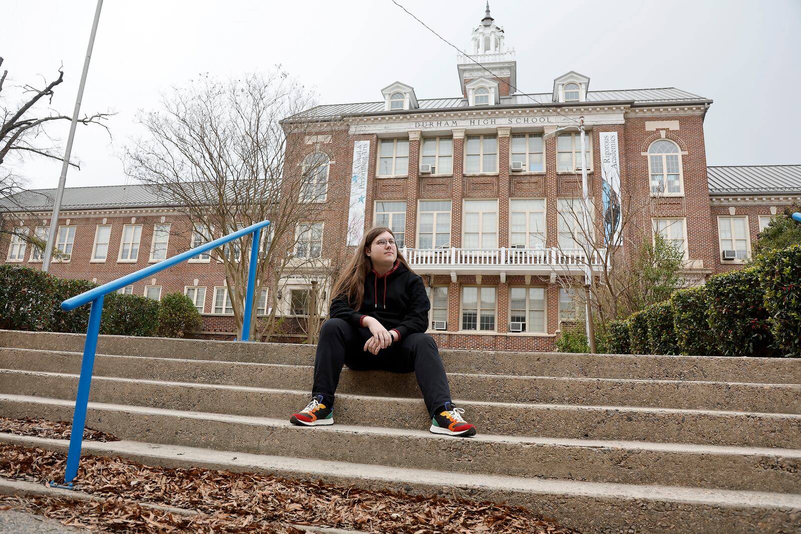 Glenn Thompson, a Durham School of the Arts graduate, poses in front of the school in Durham, N.C., Monday, March 10, 2025. (AP Photo/Karl DeBlaker)