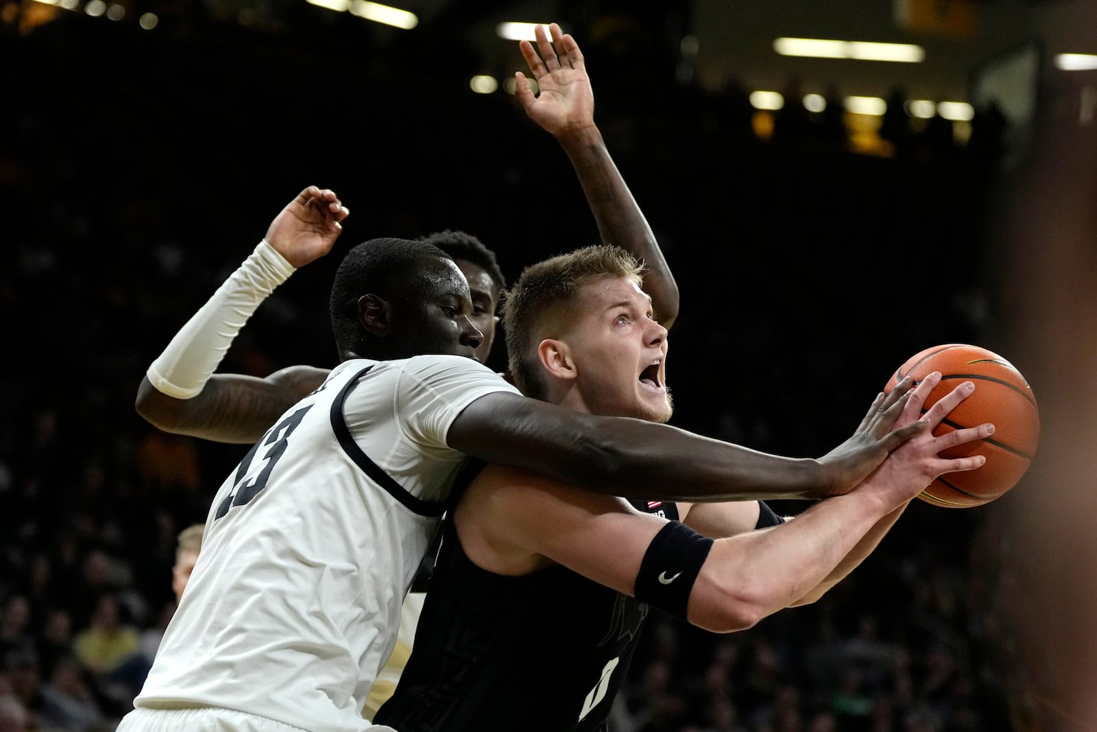 Michigan State forward Jaxon Kohler, right, is fouled by Iowa forward Ladji Dembele, left, during the first half of an NCAA college basketball game, Thursday, March 6, 2025, in Iowa City, Iowa. (AP Photo/Charlie Neibergall)