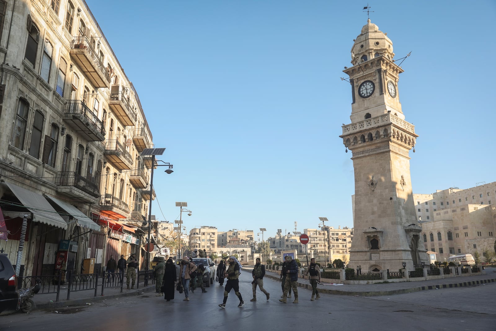 Syrian opposition fighters patrol along the streets of Aleppo, Syria, Saturday Nov. 30, 2024. (AP Photo/Ghaith Alsayed)