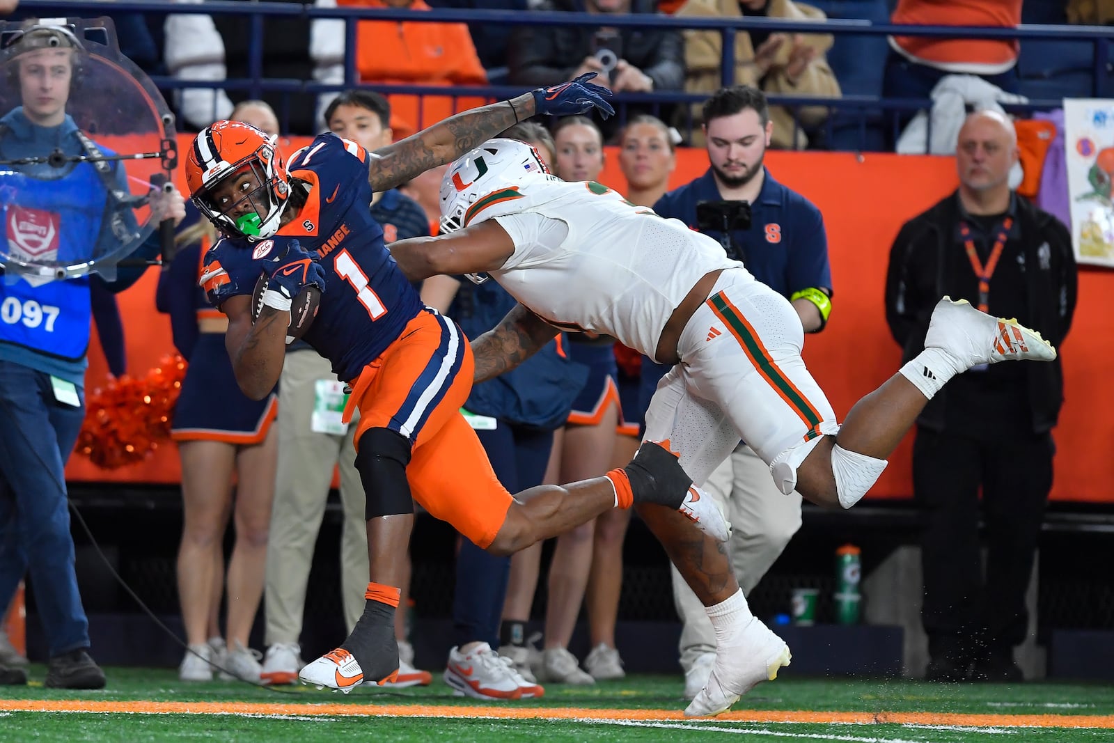 Syracuse running back LeQuint Allen (1) is pushed out of bounds by Miami linebacker Wesley Bissainthe (31) during the first half of an NCAA football game Saturday, Nov. 30, 2024, in Syracuse, N.Y. (AP Photo/Adrian Kraus)