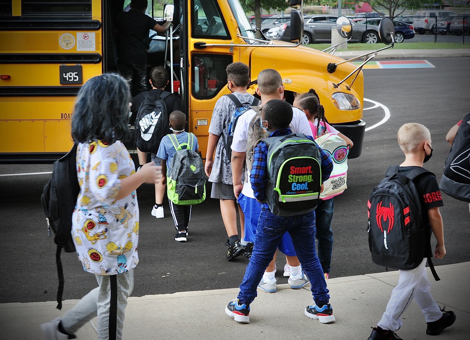 Students at Eastmont elementary in Dayton wait to board the bus at the end of the first day of school on Wednesday Aug. 18, 2021. MARSHALL GORBY\STAFF