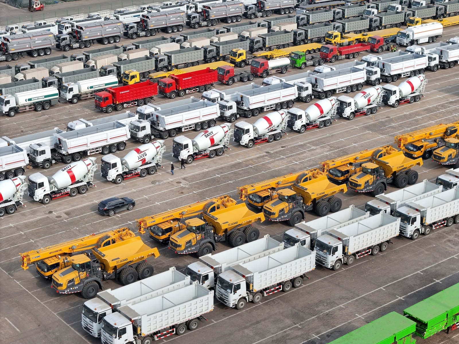 FILE - Trucks and engineering vehicles for export wait for transportation from a port in Yantai in eastern China's Shandong province Tuesday, Nov. 19, 2024. (Chinatopix Via AP, File)