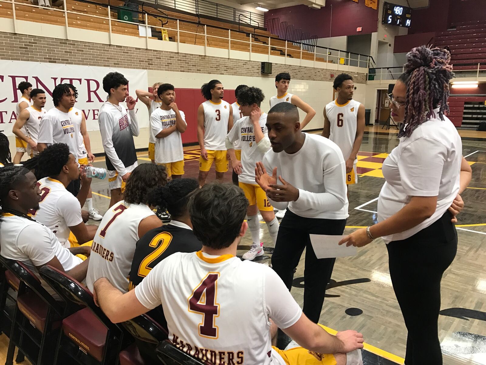 Central State men's volleyball coach Devin Walker (left) and his assistant Candace Lunford talk to the team during Wednesday night's match vs. USC. Tom Archdeacon/CONTRIBUTED