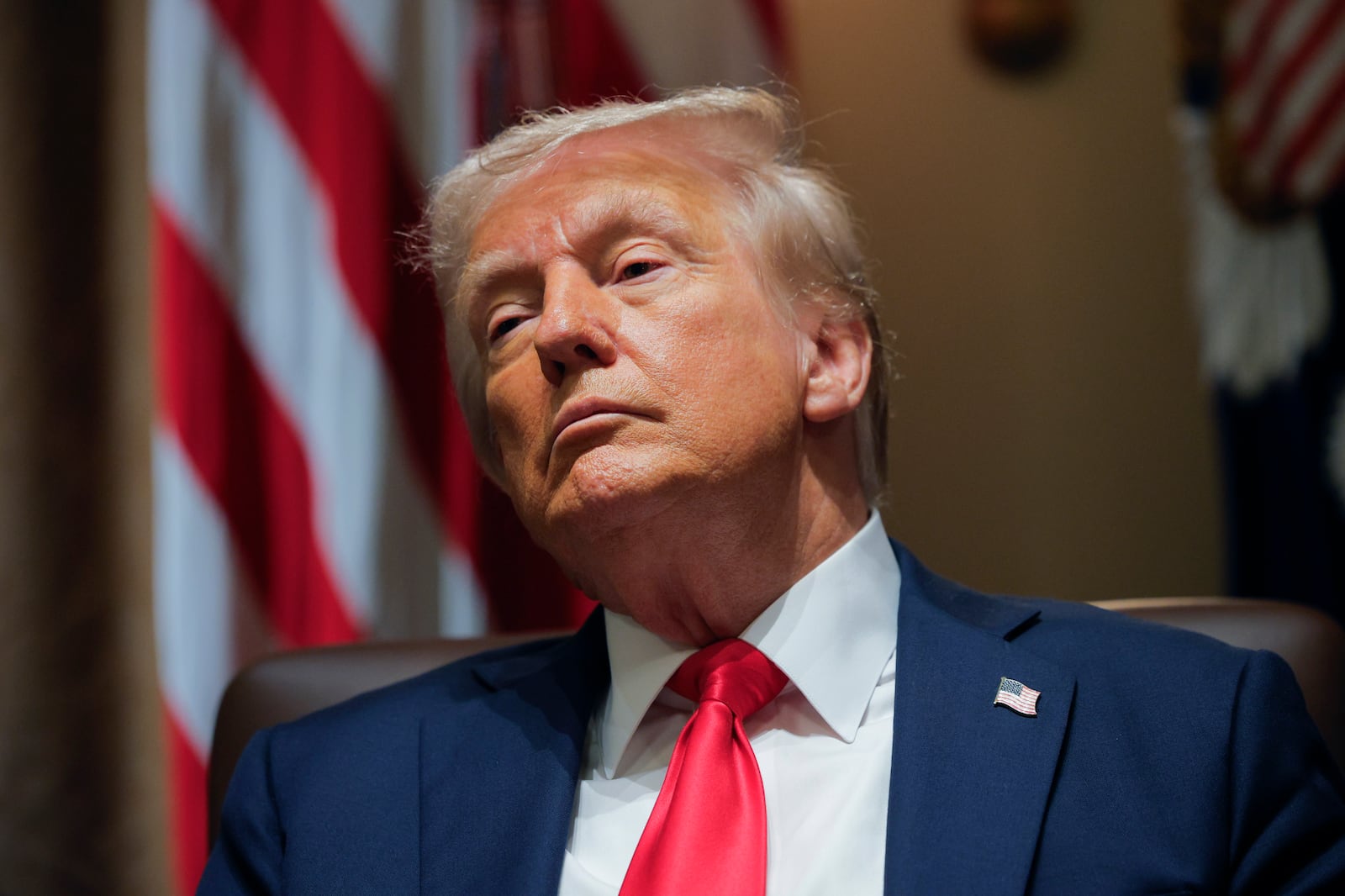 President Donald Trump listens during a Cabinet meeting at the White House in Washington, Tuesday, Feb. 26, 2025. (Pool via AP)