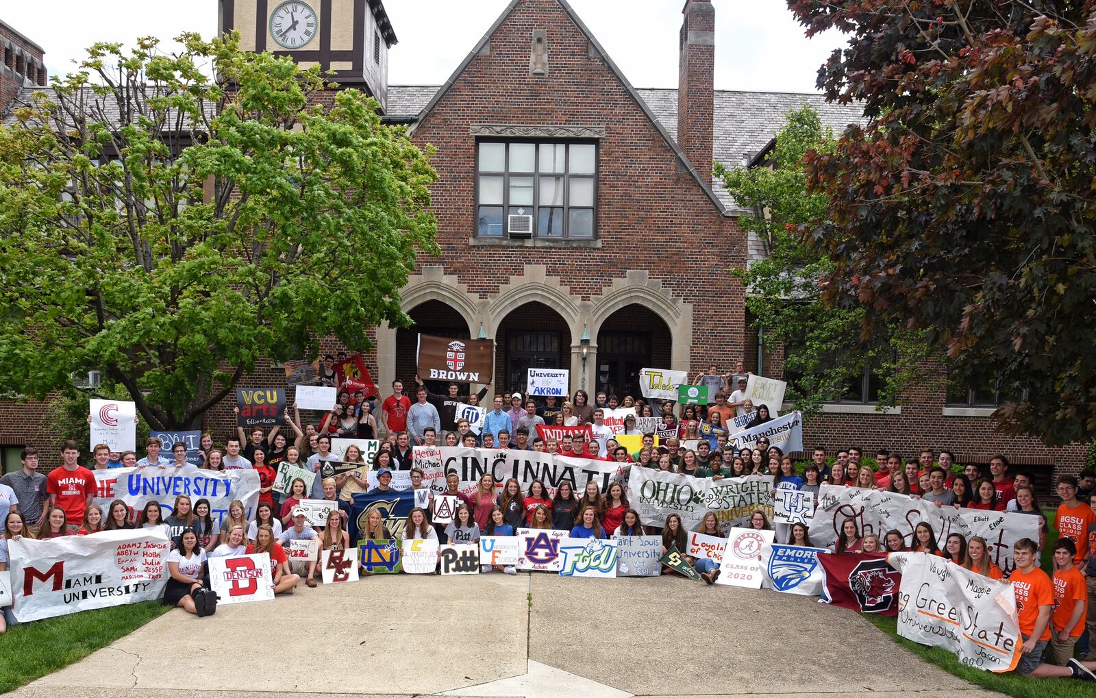 In an annual tradition, the Oakwood High School Class of 2016 gathers in front of the school displaying banners for the colleges they will attend. CONTRIBUTED