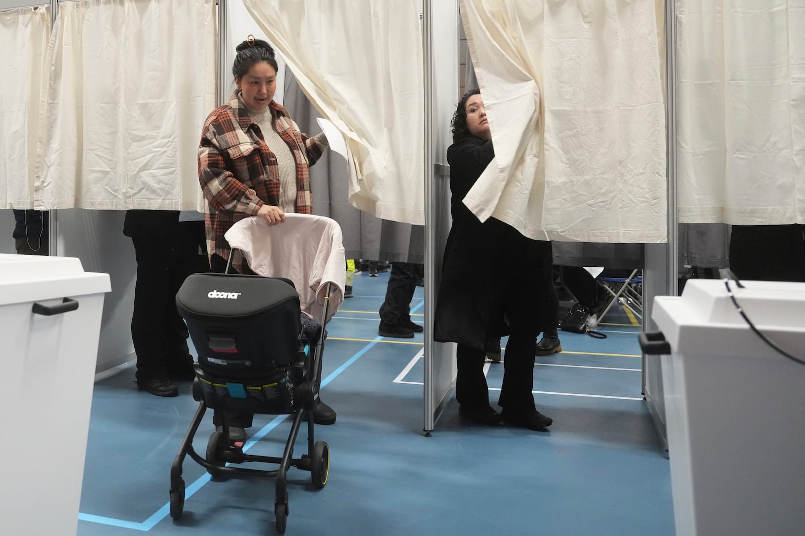 People cast their vote in parliamentary elections in Nuuk, Greenland, Tuesday, March 11, 2025. (AP Photo/Evgeniy Maloletka)