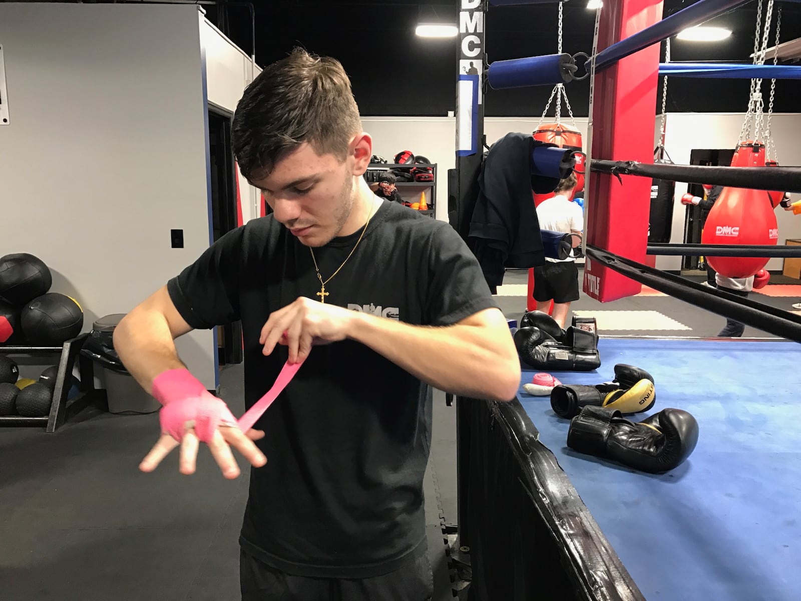 Liam Walsh wraps his hands before Monday night’s training session at the DMC Boxing Academy in Centerville. Tom Archdeacon/CONTRIBUTED