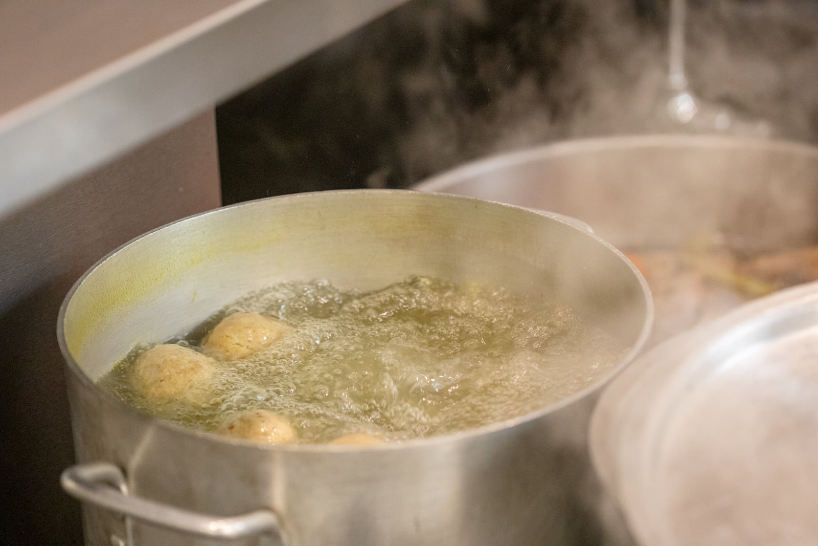 All The Best Delicatessen's homestyle matzo balls are a mix of matzo meal, eggs, schmaltz and canola oil. Once they are rolled and ready each matzo ball is poached for 10-15 minutes in boiling water and served.