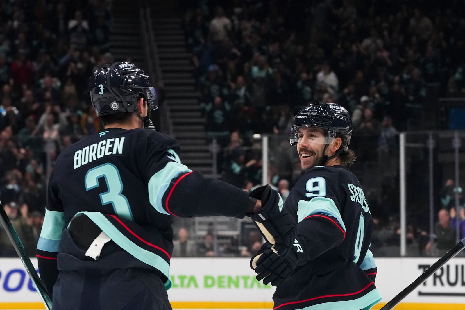 Seattle Kraken defenseman Will Borgen (3) celebrates his goal against the Columbus Blue Jackets with center Chandler Stephenson (9) during the second period of an NHL hockey game Tuesday, Nov. 12, 2024, in Seattle. (AP Photo/Lindsey Wasson)