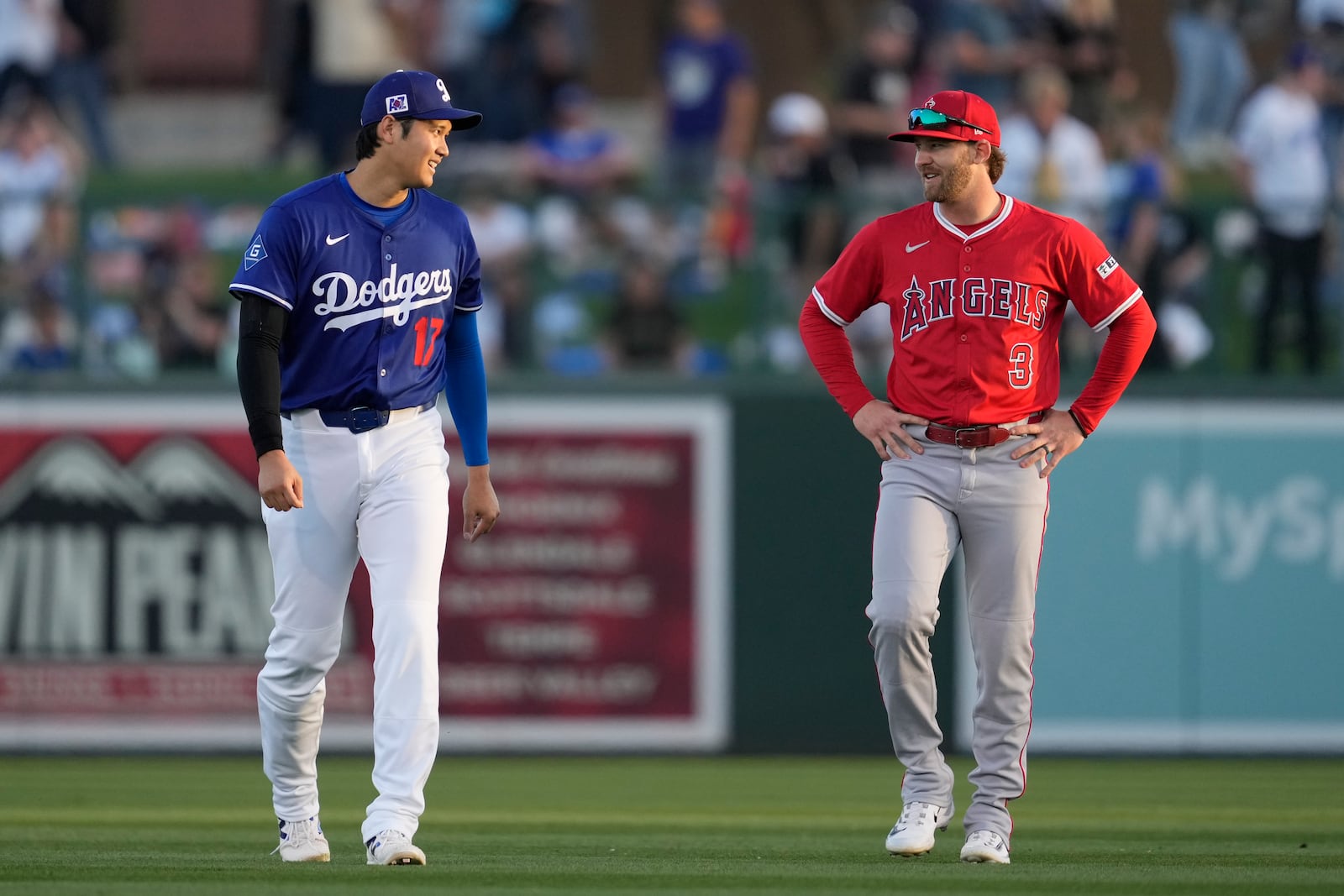 Los Angeles Dodgers designated hitter Shohei Ohtani (17) greets Los Angeles Angels left fielder Taylor Ward (3) before a spring training baseball game, Friday, Feb. 28, 2025, in Phoenix. (AP Photo/Ashley Landis)