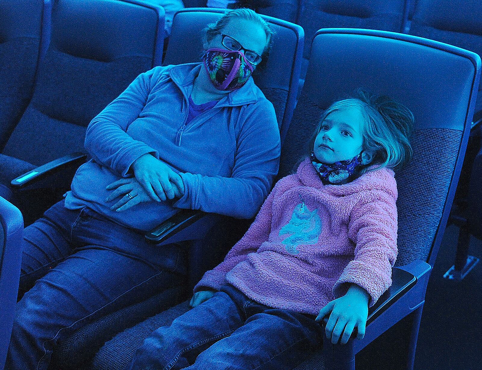 Megan Chomic, with her daughter, Margaret, age 7, wait to see Dayton resident Larry Connor, talk to the Boonshoft Museum from the International Space Station Tuesday April 12, 2022. The event was open to the public. MARSHALL GORBY\STAFF