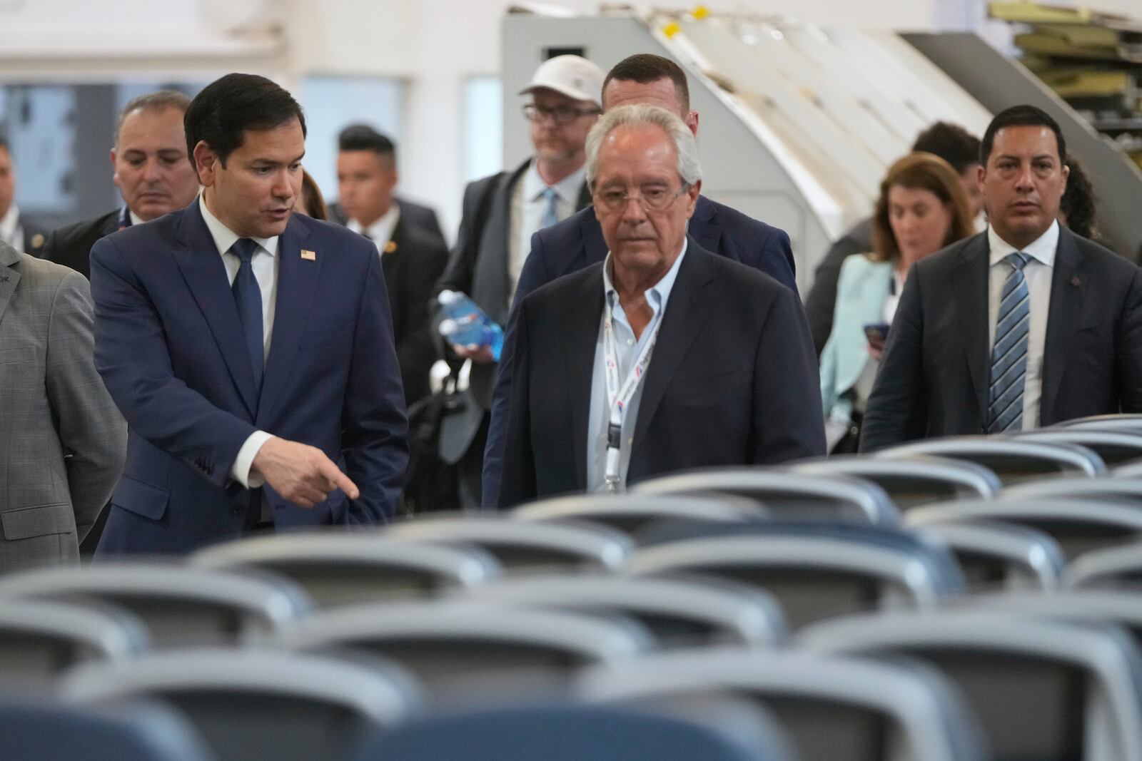 U.S. Secretary of State Marco Rubio talks to Roberto Kriete, right, during a visit to the facilities of aircraft maintenance firm Aeroman in San Luis Talpa, El Salvador, Monday, Feb. 3, 2025. (AP Photo/Mark Schiefelbein, Pool)