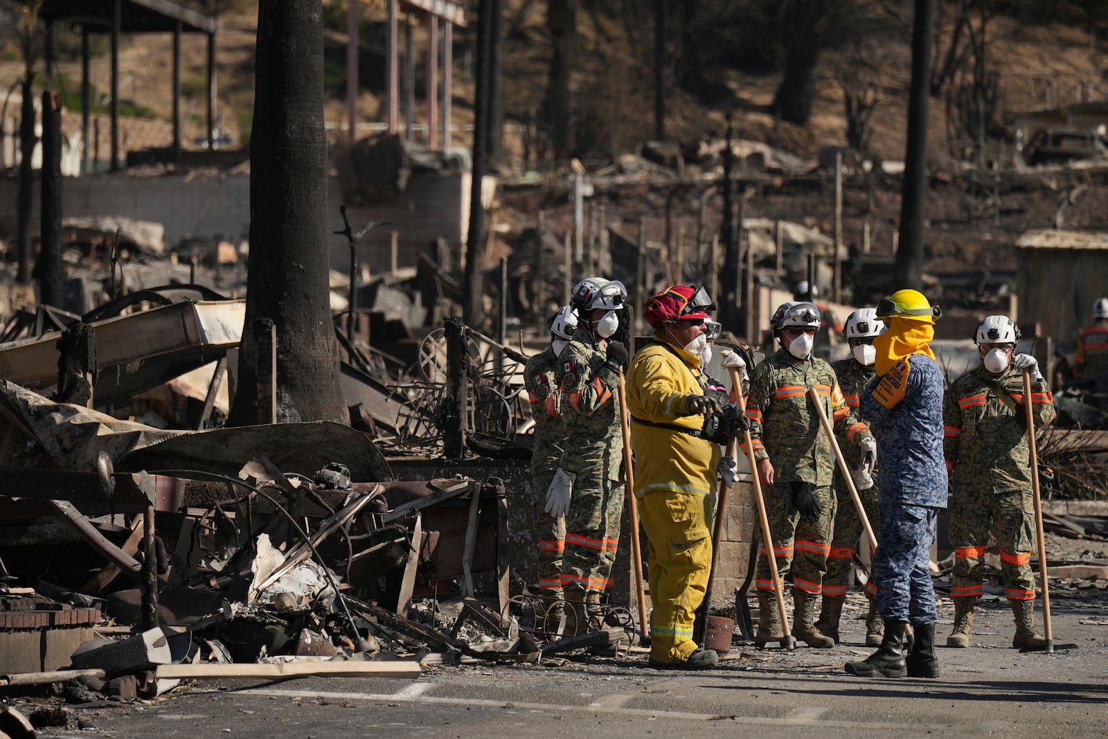 Search and rescue crew inspect a mobile home park destroyed by the Palisades Fire in Palisades, Calif. is seen, Wednesday, Jan. 15, 2025. (AP Photo/Jae C. Hong)