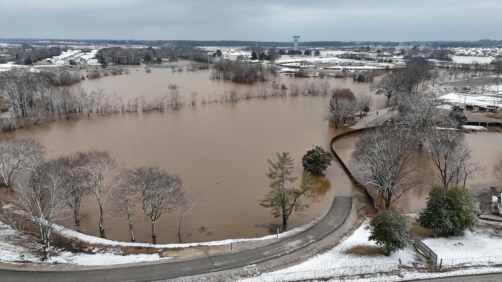 A high-rising Barren River flows through Bowling Green, Ky., Sunday, Feb. 16, 2025, after heavy rainfall beginning early Saturday morning brought nearly five inches of rain and snowfall to Warren County. (Jack Dobbs/Daily News via AP)