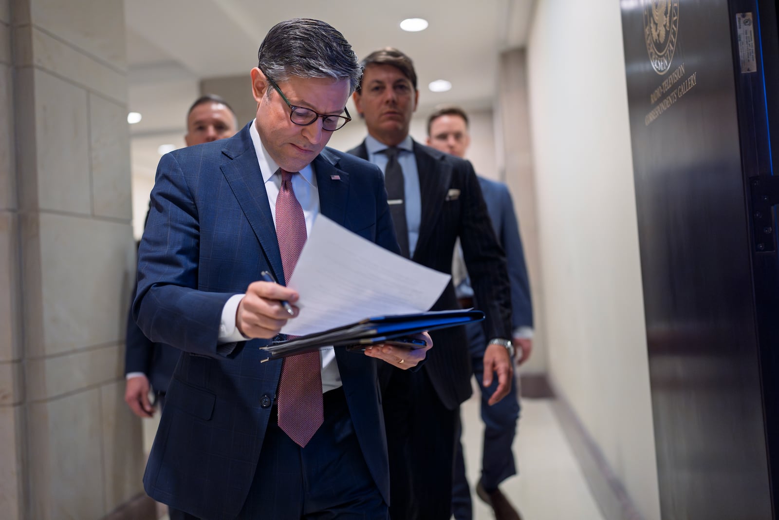 Speaker of the House Mike Johnson, R-La., arrives to talk to reporters after a closed-door meeting with fellow Republicans to find agreement on a spending bill, at the Capitol in Washington, Tuesday, Feb. 11, 2025. (AP Photo/J. Scott Applewhite)