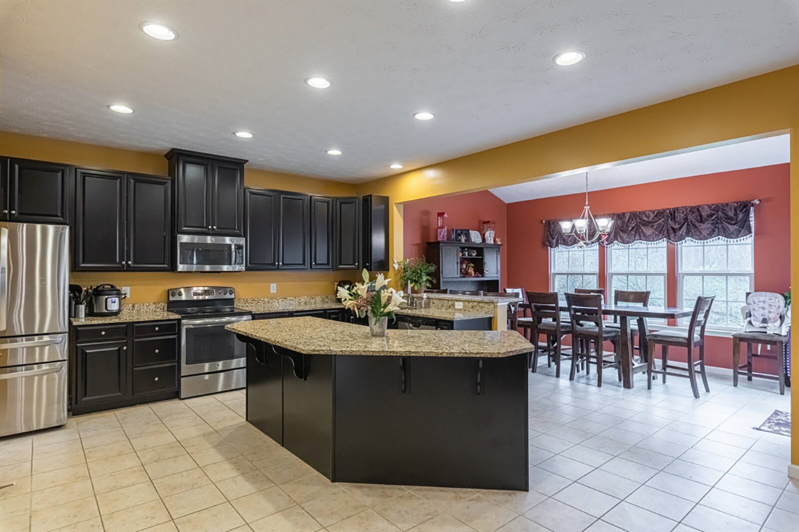 The kitchen has dark 42-inch cabinetry that fills one wall and wraps around along a peninsula counter that divides the kitchen from the morning room. Light granite countertops complement the cabinetry, which also includes an angled island with breakfast bar seating and storage. 
CONTRIBUTED PHOTO