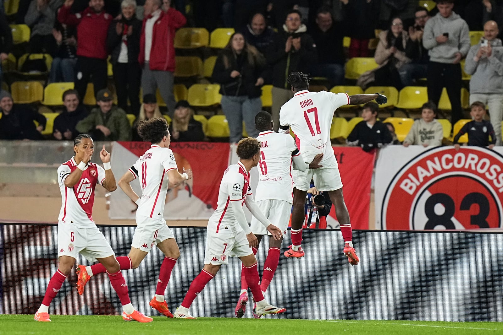 Monaco's Wilfried Singo, right, celebrates after scoring the opening goal of his team during a Champions League opening phase soccer match between Monaco and Aston Villa at the Louis II stadium in Monaco, Tuesday, Jan. 21, 2025. (AP Photo/Laurent Cipriani)