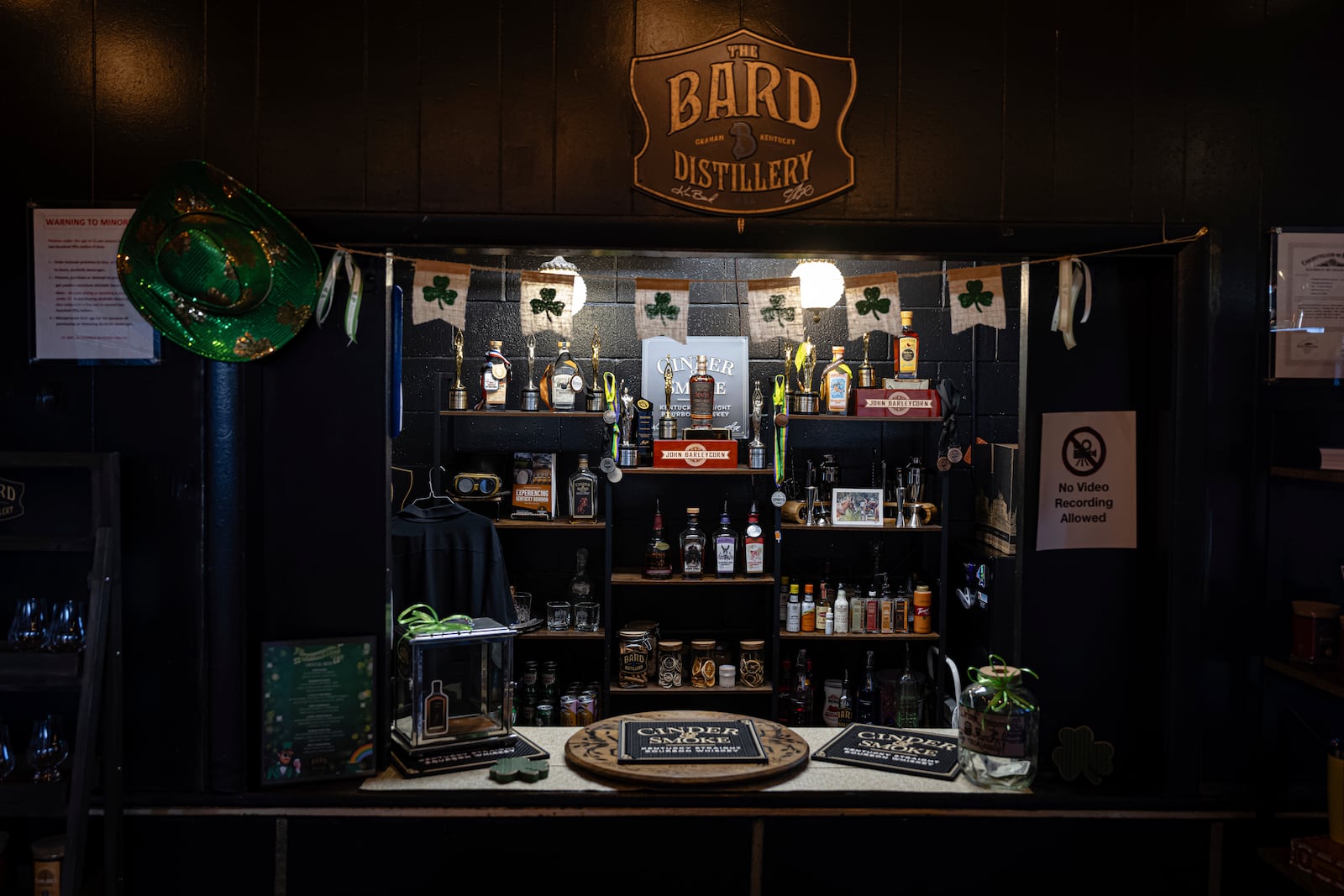 Bottles and decorations are seen in the tasting area of The Bard Distillery in Graham, Ky., Sunday, March 9, 2025. (AP Photo/Jon Cherry)