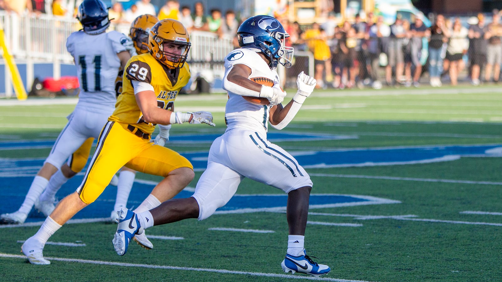 Fairmont's Damien Pattin runs for yardage as he is chased by Alter's Connor Watkins during a game earlier this season. Jeff Gilbert/CONTRIBUTED