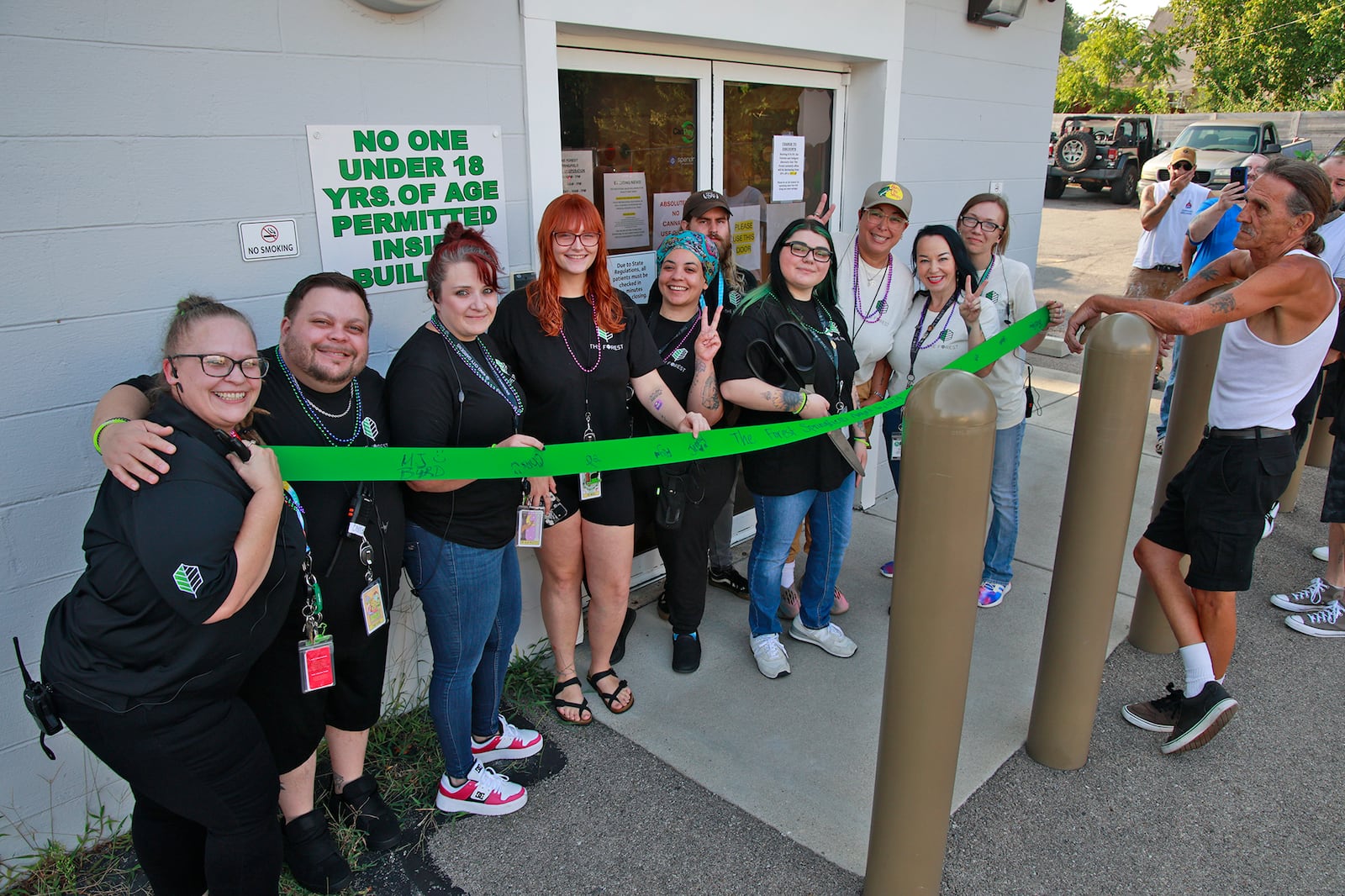 The staff of Springfield marijuana business The Forest held a ribbon-cutting Tuesday, August 6, 2024 before the beginning of legal recreational marijuana sales. BILL LACKEY/STAFF