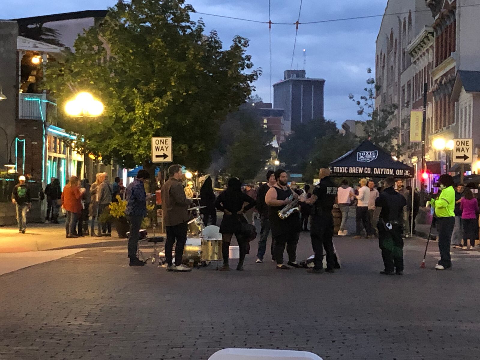 A photo of police talking to a street band in the Oregon District in early October. Crowding in the Oregon District was a major problem on Saturday night. CORNELIUS FROLIK / STAFF 