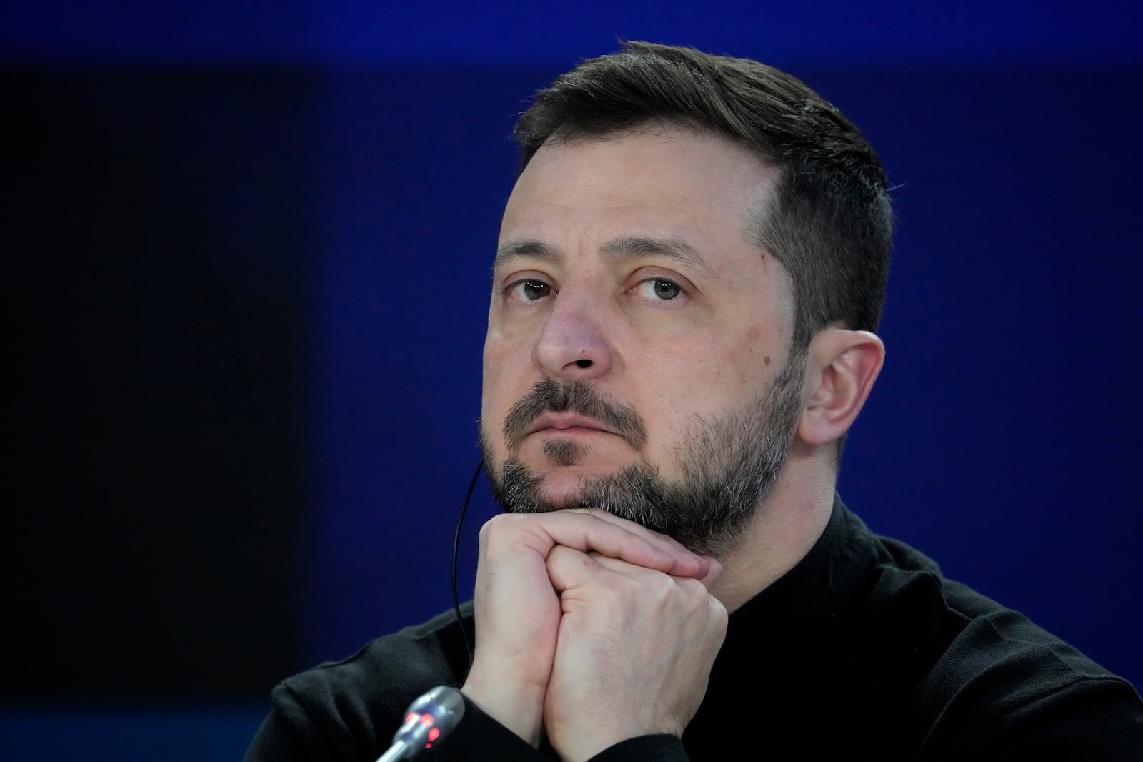 Ukrainian President Volodymyr Zelenskyy listens during a news conference at a security summit in Kyiv, Ukraine, Monday, Feb. 24, 2025. (Frank Gunn/The Canadian Press via AP)