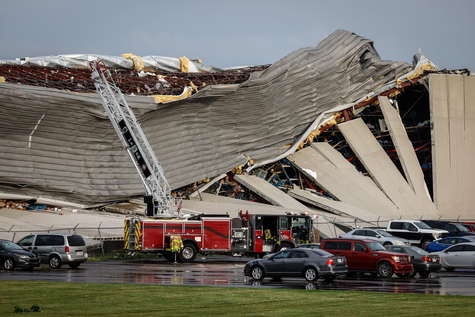 Firefighters are shown near the damage at the Meijer Distribution Center in Tipp City near Interstate 75 after a tornado struck the area on Wednesday, June 8, 2022. JIM NOELKER/STAFF