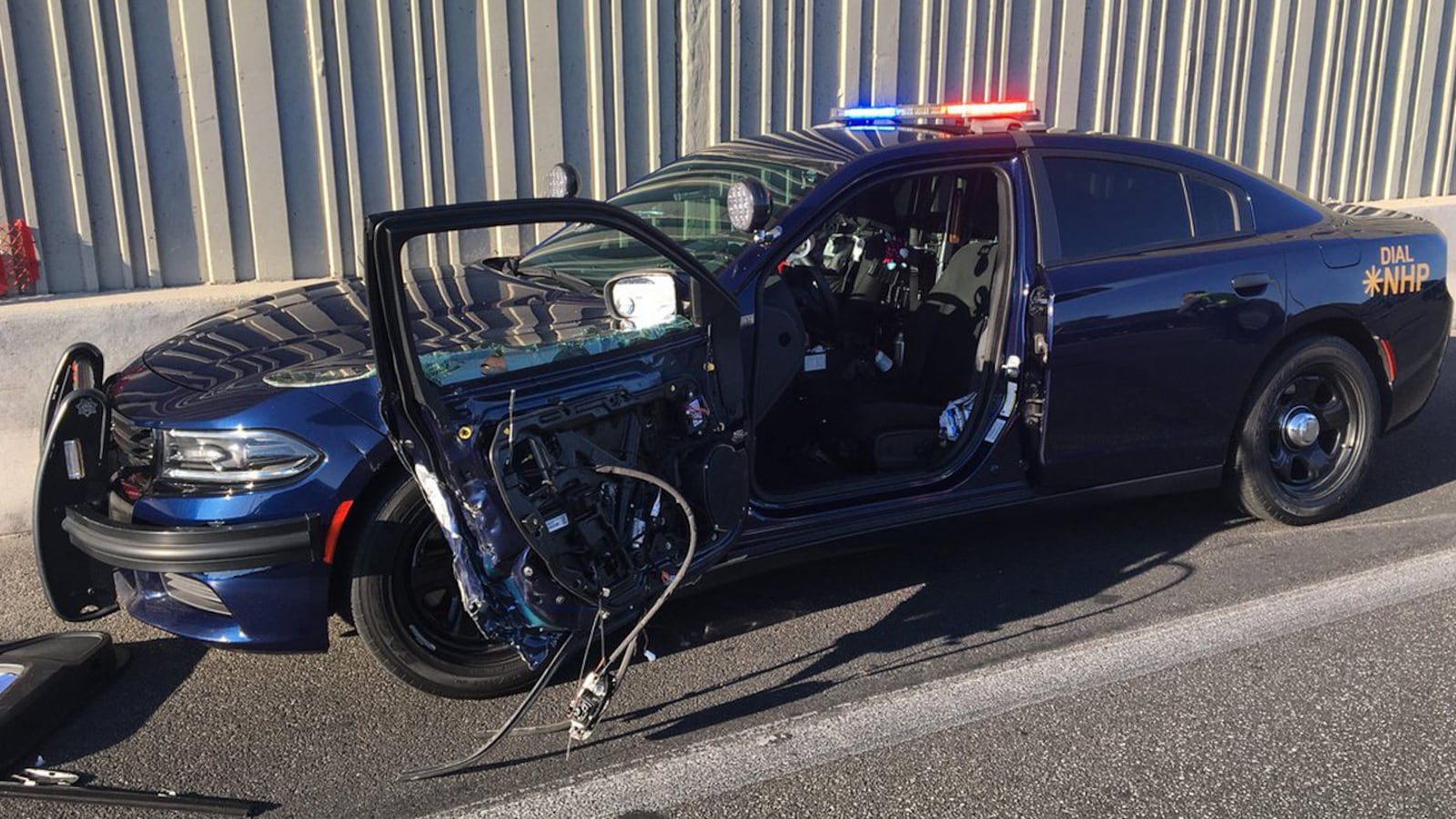 Police said a driver was unable to move lanes when she came upon a traffic stop and crashed into the opened door of a cruiser. Police said she then left the scene of the accident.