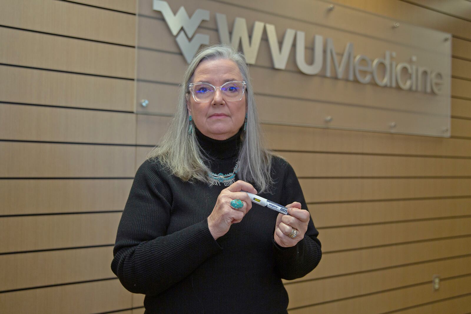 Patient Lory Osborn holds a Wegovy pen used in her treatment at the Medical Weight Management office at West Virginia University in Morgantown, W.Va., Monday, Dec. 2, 2024. (AP Photo/Kathleen Batten)