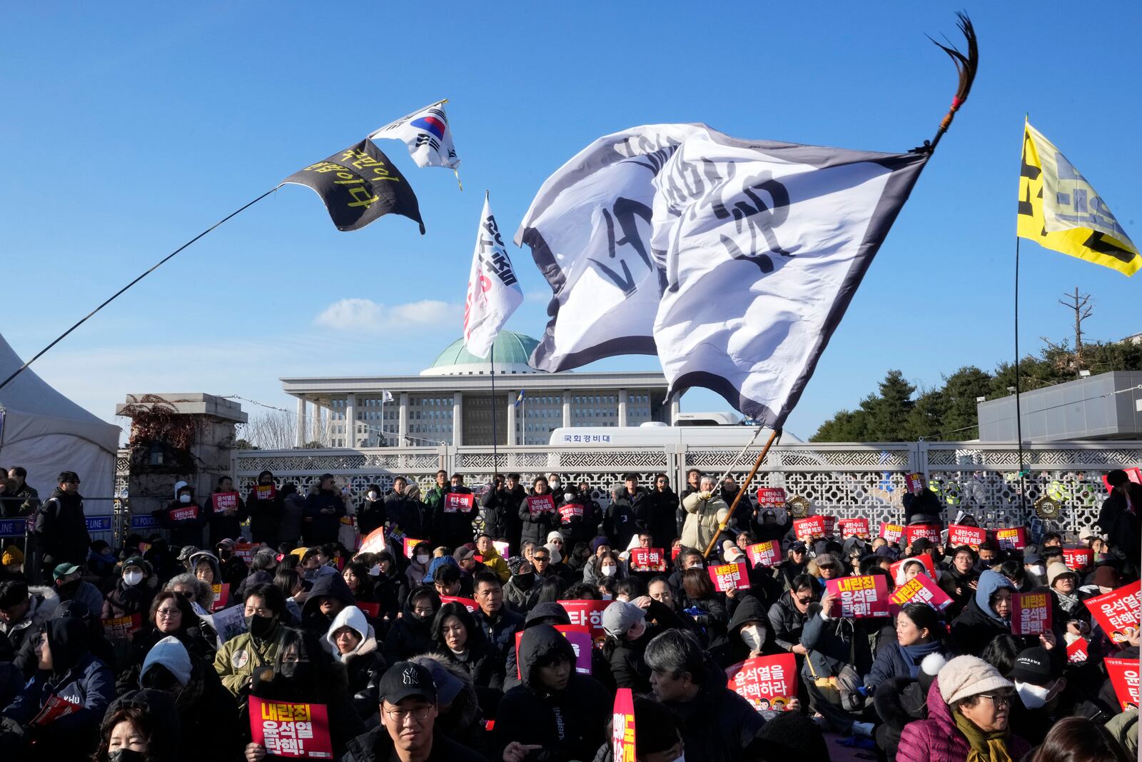 Protesters attend a rally demanding South Korean President Yoon Suk Yeol's impeachment, in front of the National Assembly in Seoul, South Korea, Saturday, Dec. 7, 2024, following the president's short-lived martial law declaration. (AP Photo/Ahn Young-joon)