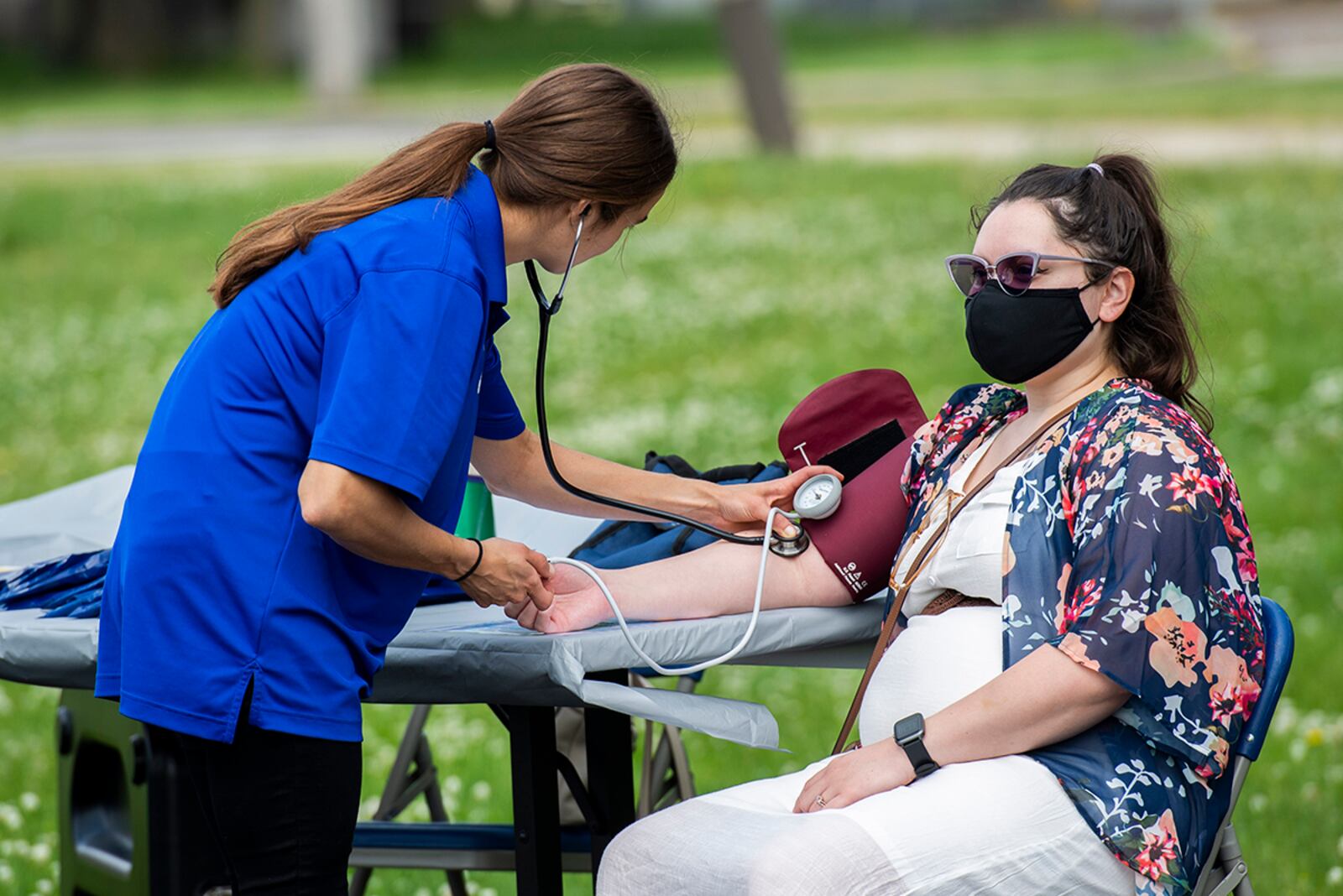 Olivia Lehman (left), health promotion coordinator with Civilian Health Promotion Services, checks the blood pressure of Christina Pico-Carbajal, a family member, during the annual Fit Fest event May 27 at Wright-Patterson Air Force Base. U.S. AIR FORCE PHOTO/WESLEY FARNSWORTH