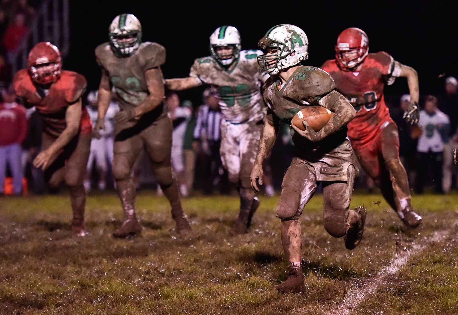 Anna’s Riley Huelskamp carries the ball during their 14-10 loss to Madison in their playoff game Friday, Nov. 3 at Madison High School in Madison Township. NICK GRAHAM/STAFF