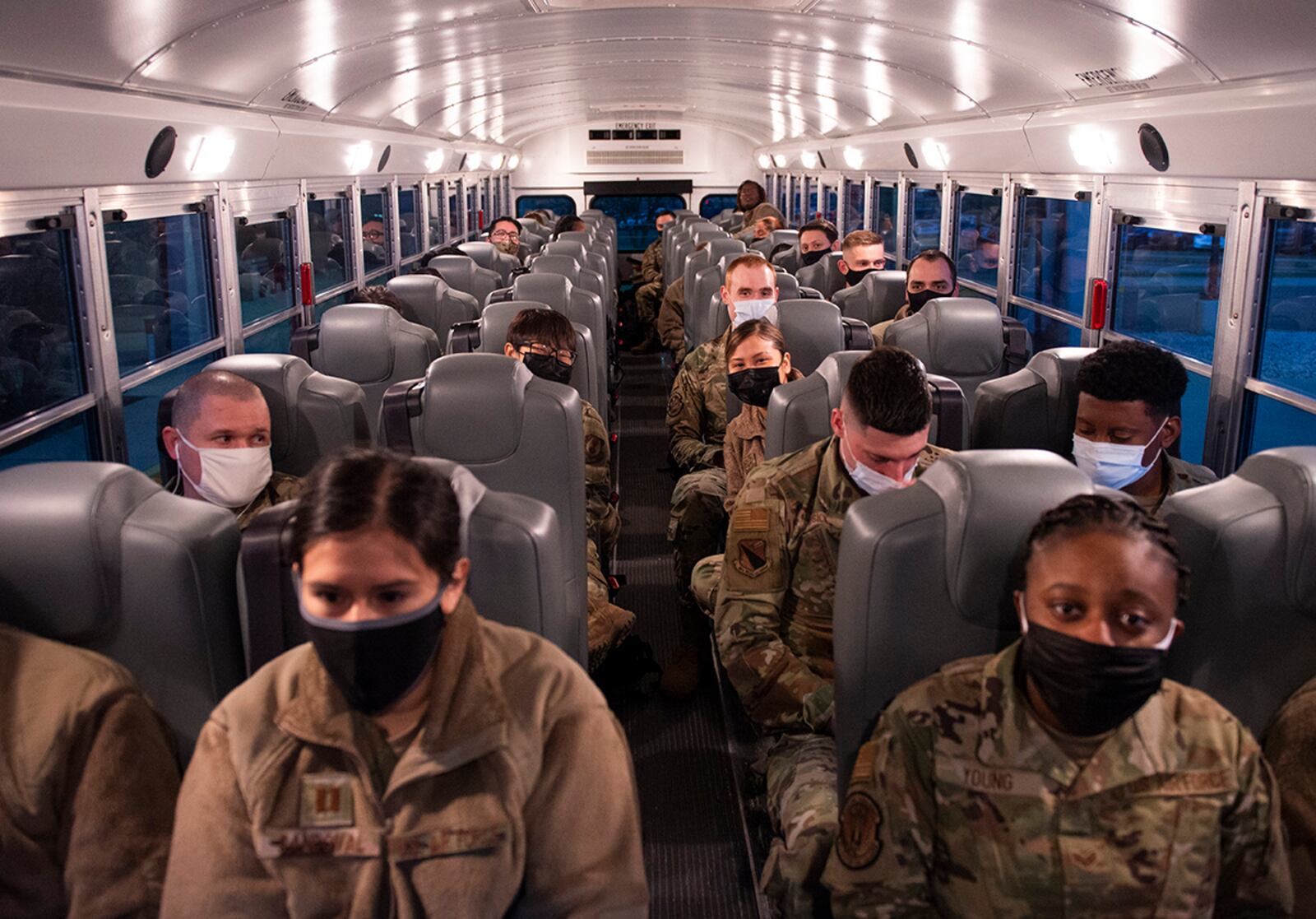 Airmen from the 88th Medical Group wait on a bus outside Wright-Patterson Medical Center on March 19 as they deploy to Detroit in support of the Federal Emergency Management Agency’s COVID-19 response. According to the Federal Emergency Management Agency, military and support personnel throughout the country have already administered about 700,000 vaccines, and a single Type 1 team is capable of delivering 6,000. U.S. AIR FORCE PHOTO/WESLEY FARNSWORTH