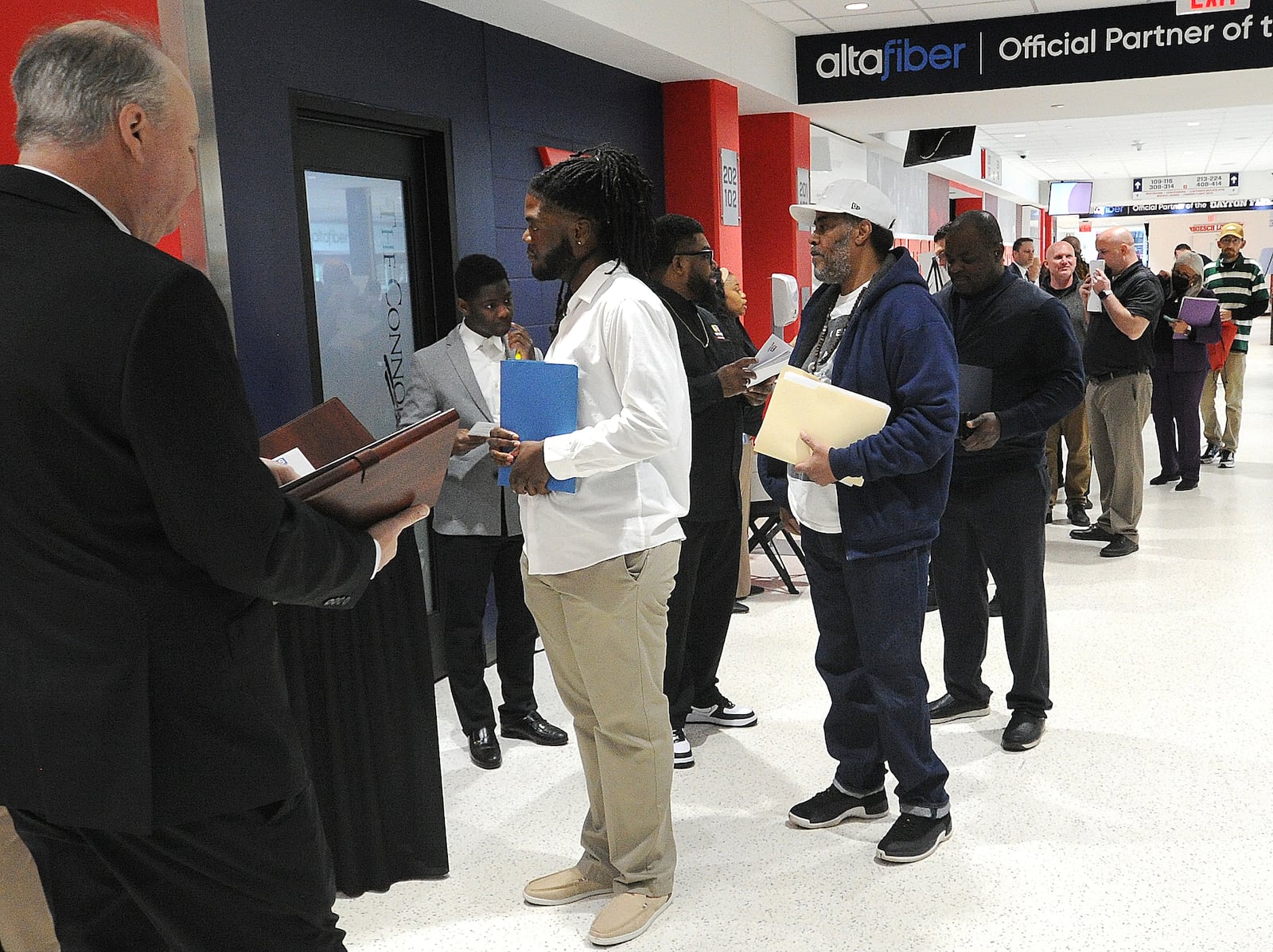 Job seekers lined up to register at the Montgomery County Workforce Development Services Spring Job Fair Thursday, April 27, 2023 at the University of Dayton Arena. MARSHALL GORBY\STAFF