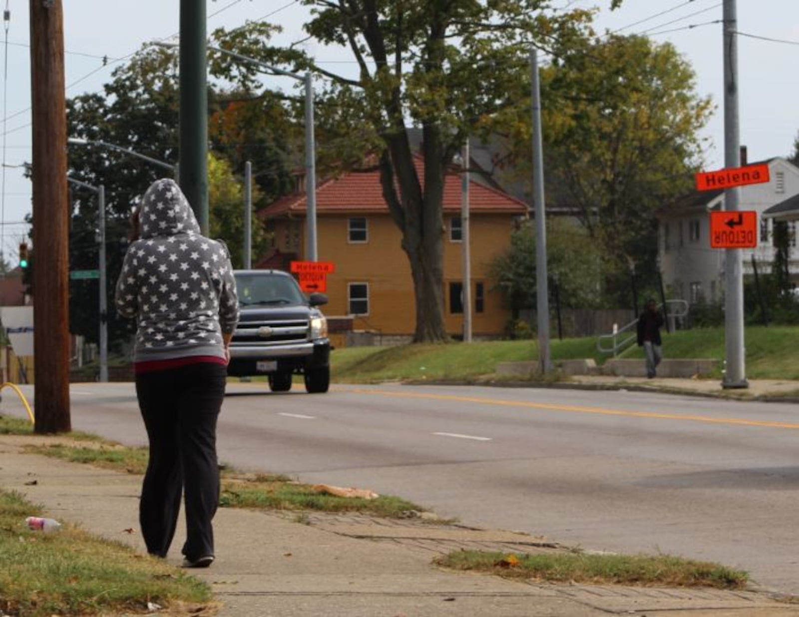 A woman walks along North Main Street, headed toward Helena Street. CORNELIUS FROLIK / STAFF